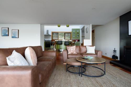 a living room with a couch and a table at Scenic Getaway with Breathtaking Water Views in Gordon