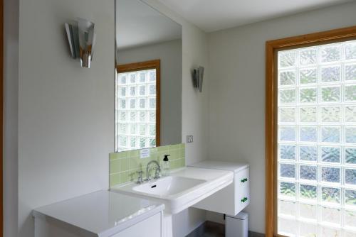 a bathroom with a sink and a window at Scenic Getaway with Breathtaking Water Views in Gordon