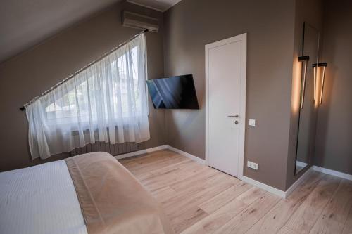 a bedroom with a bed and a window and a door at R.HOTEL in Chernivtsi