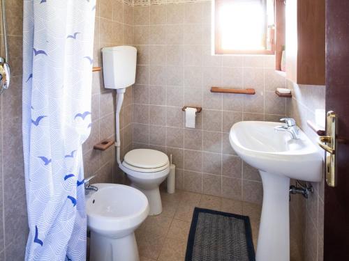 a bathroom with a toilet and a sink at Cottage in Parole near Forest and Lake in Crone