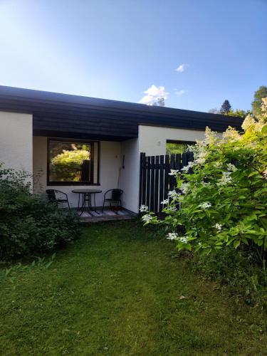 a house with a patio and a table in the yard at Honkatilat majoitus as 2 in Kajaani