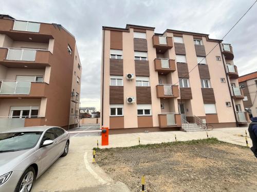 a car parked in front of a building at Mikos apartmani in Belgrade