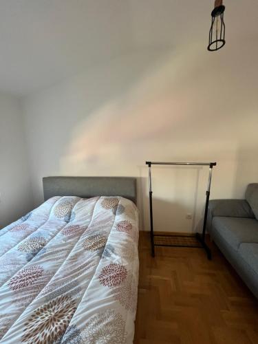a bed and a couch in a room at Mikos apartmani in Belgrade