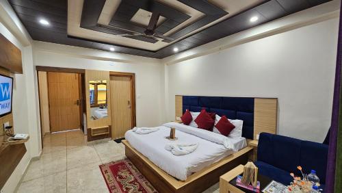 a bedroom with a large bed and a couch at Hotel Green View McLeod Ganj in Dharmsala