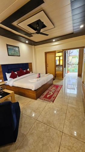 a bedroom with a large bed in a room at Hotel Green View McLeod Ganj in Dharmsala