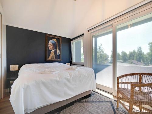 a bedroom with a bed and a large window at Family House in Grou near Water Sports in Grou
