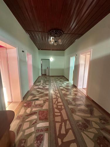 an empty hallway with a tile floor in a building at Xhiu guest house in Krujë