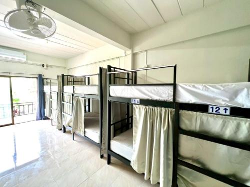 a group of bunk beds in a room at Klong Muang Hostel คลองม่วงโฮสเทล in Ban Ko Kwang