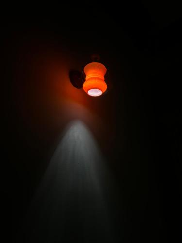 an orange light in the dark with a spotlight at Lý Sơn I Xuân Mai Homestay in Quang Ngai