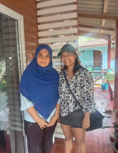 two women are standing next to each other at Goodluck village house in Koh Mook