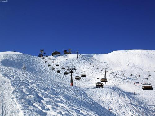 a snow covered ski slope with a ski lift at Apartment in Hüttschlag near Ski Bus in Hüttschlag