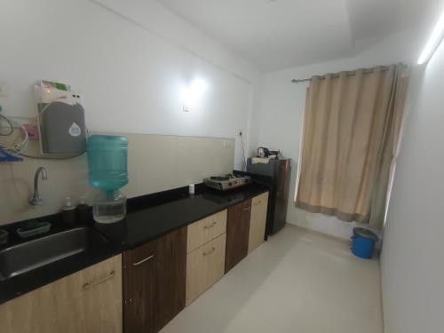 a kitchen with a black counter and a sink at Sky line villa, Lonavla in Lonavala