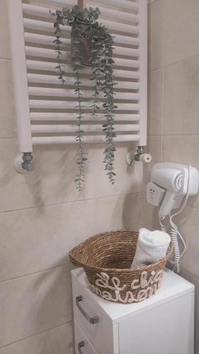 a bathroom with a basket on top of a toilet at La Maison de Maricla' in Pietrelcina