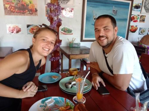 a man and a woman sitting at a table at Goodluck village house in Koh Mook
