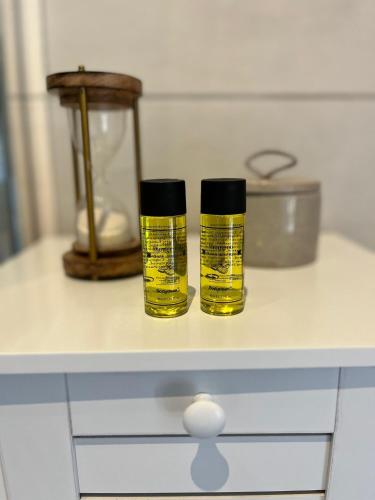 two bottles of oil sitting on top of a counter at Charmant studio à 10 min de Lyon in Miribel
