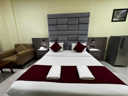 a bedroom with a large bed and a couch at ROYAL HOTEL in Muscat