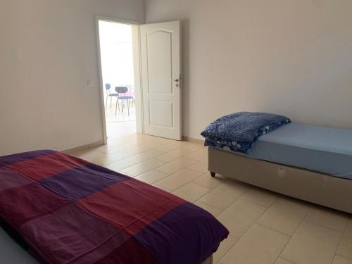 a bedroom with a bed and a door to a patio at Homely 2,5 room apartment in Safenwil
