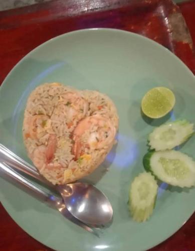 a plate of food with shrimp and vegetables on a table at Goodluck village house in Koh Mook
