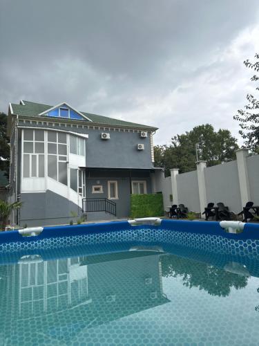 a swimming pool in front of a house at Sheki GuestHouse in Sheki