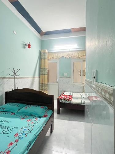 a bedroom with a bed and two beds in it at Lý Sơn I Xuân Mai Homestay in Quang Ngai