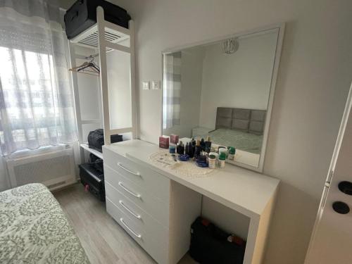 a bathroom with a white vanity with a large mirror at Appartamento MALI I ROBIT in Golem