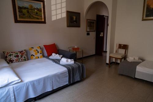 a room with a bed and a couch and a chair at Lemon Garden Home in Rome