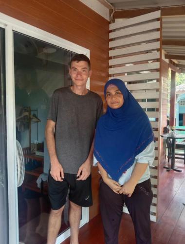a man and a woman standing in a room at Goodluck village house in Koh Mook