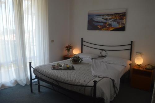 a bedroom with a bed with a tray of food on it at Hotel Belvedere in Passignano sul Trasimeno