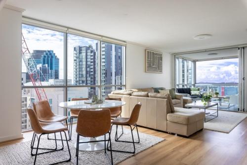 a living room with a couch and a table and chairs at Luxury Apartment Brisbane CBD in Brisbane