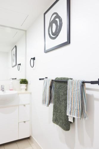 a bathroom with a towel hanging on a towel rack at Luxury Apartment Brisbane CBD in Brisbane