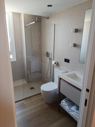 a bathroom with a shower and a toilet and a sink at Hotel Las Rocas de Isla in Isla