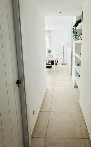 a hallway with white walls and a tiled floor at Altea Lighthouse in Altea