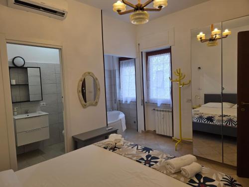 a bathroom with a bed and a mirror and a sink at Alloggio turistico di Stefano in Lido di Ostia