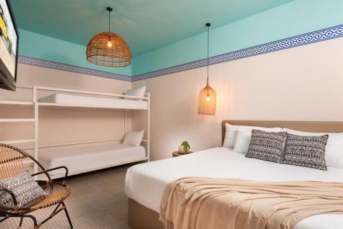 a bedroom with a bed and a chair and a couch at U Splash Resort Eilat in Eilat