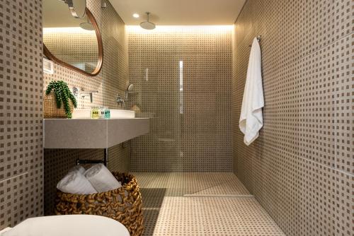 a bathroom with a shower and a toilet and a sink at U Splash Resort Eilat in Eilat