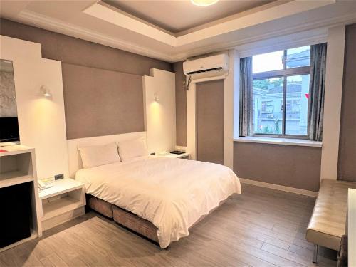 Ένα ή περισσότερα κρεβάτια σε δωμάτιο στο Guest Motel-Zhubei