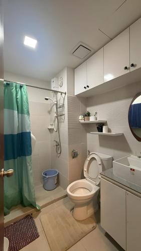 a bathroom with a toilet and a shower at JPD Mesavirre Garden Residences in Bacolod