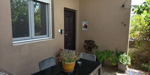 a table and chairs in front of a house at Lemon Home in Heraklio Town