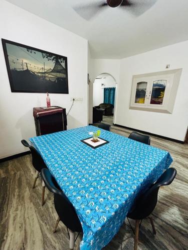 a room with a table with a blue table cloth on it at Bacadi Inn Holiday Home in Ernakulam