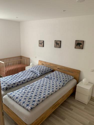 a bedroom with two beds with blue and white sheets at Ferienwohnung Kranichblick in Kargow