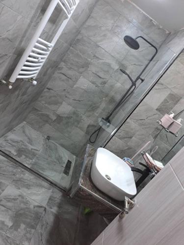 a bathroom with a toilet and a glass shower at SaintGermain in Aïn El Turk