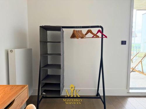 a black stand with a shelf in a room at T2 Vue Pompidou Balcon, Sport & Centre Muse in Metz