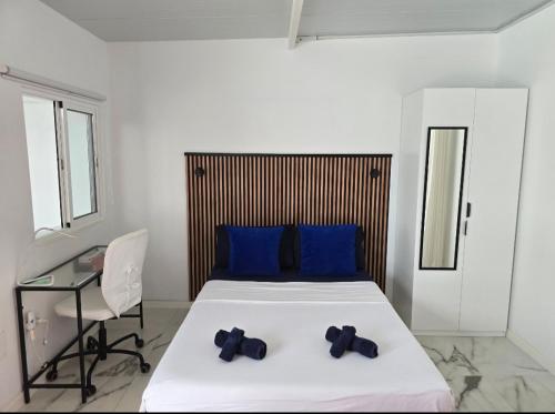 a bedroom with a bed with blue pillows and a desk at Ático Micaela. Terraza y vistas in Santa Cruz de Tenerife