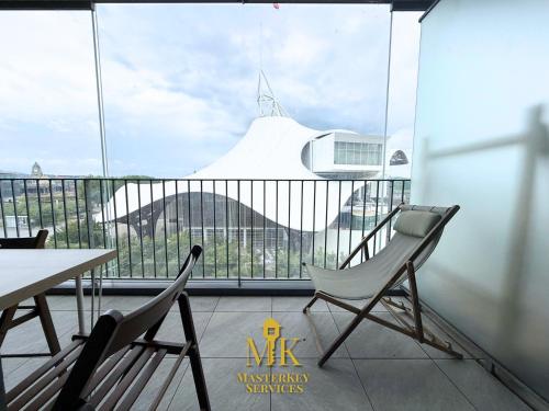 a balcony with two chairs and a table and a large window at T2 Vue Pompidou Balcon, Sport & Centre Muse in Metz