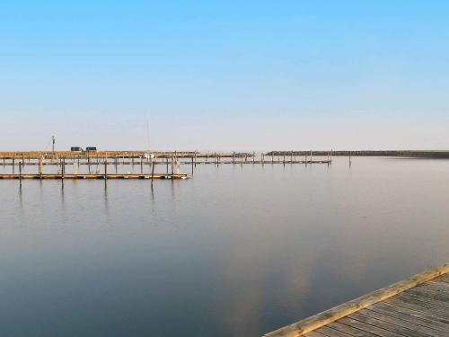 a dock on a body of water next to a pier at 5 person holiday home in Vinderup-By Traum in Vinderup