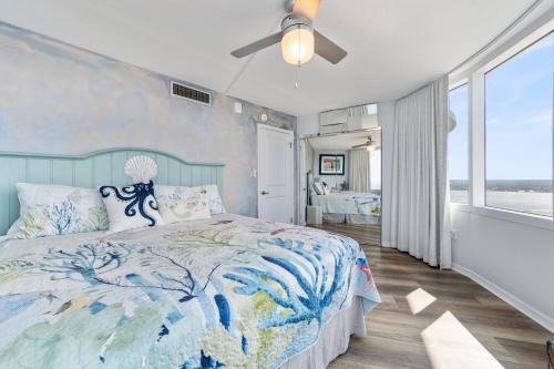 a bedroom with a bed and a ceiling fan at On the Beach-2/Br 2/Bath, 26th floor! Spectacular views of Ocean & River in Daytona Beach Shores