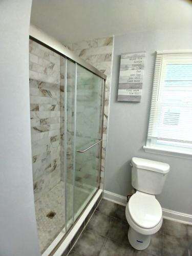 a bathroom with a shower and a toilet at Soothing Private Room in Washington DC in Washington, D.C.