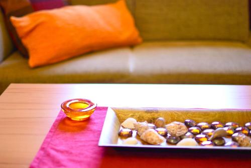 a plate of donuts on a table next to a couch at Apart of me Ferienhaus Faaker See in Egg am Faaker See