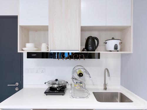 a kitchen with white cabinets and a sink and a mixer at KWEN Vetro11 - Charm of KK City in Kota Kinabalu