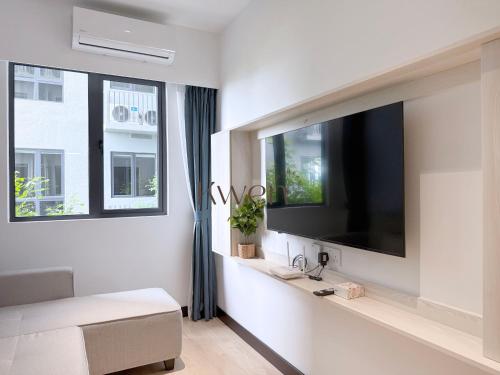 a living room with a large flat screen tv on a wall at KWEN Vetro11 - Charm of KK City in Kota Kinabalu